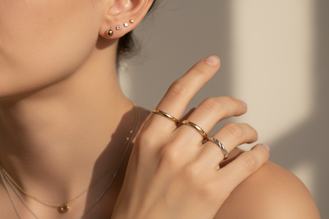 Minimal everyday jewelry styled on skin with soft lighting, highlighting comfort and simplicity.