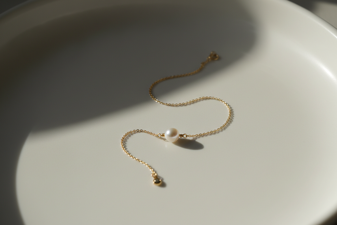 simple bracelet placed on a clean surface with soft shadows, minimal elements, one subtle focal point, natural lighting, calm and refined composition