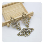 Hollow Filigree Charms - color: Antique Brass