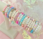 600Pcs Flat Round Vowel Letter Beads 7x4mm with Letter A E I O U Gold Letters White Acrylic Beads for Jewelry Making with Colorful Smiling Faces and Heart - color: Mixed Gold